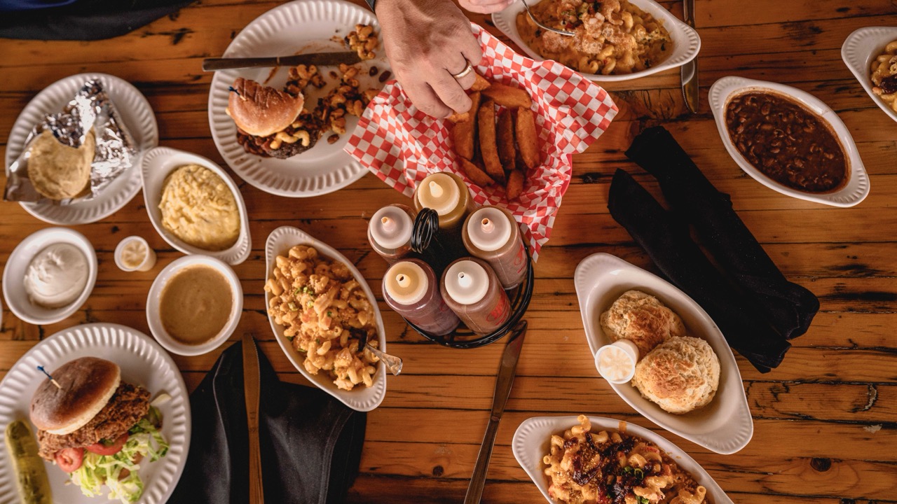 Menu Large Assorted Southern comfort food on wooden table.